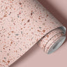 Contact paper 111: A roll of blush pink terrazzo wallpaper with speckled accents in soft pink, beige, and terracotta tones, designed for modern interiors and cozy accent walls.