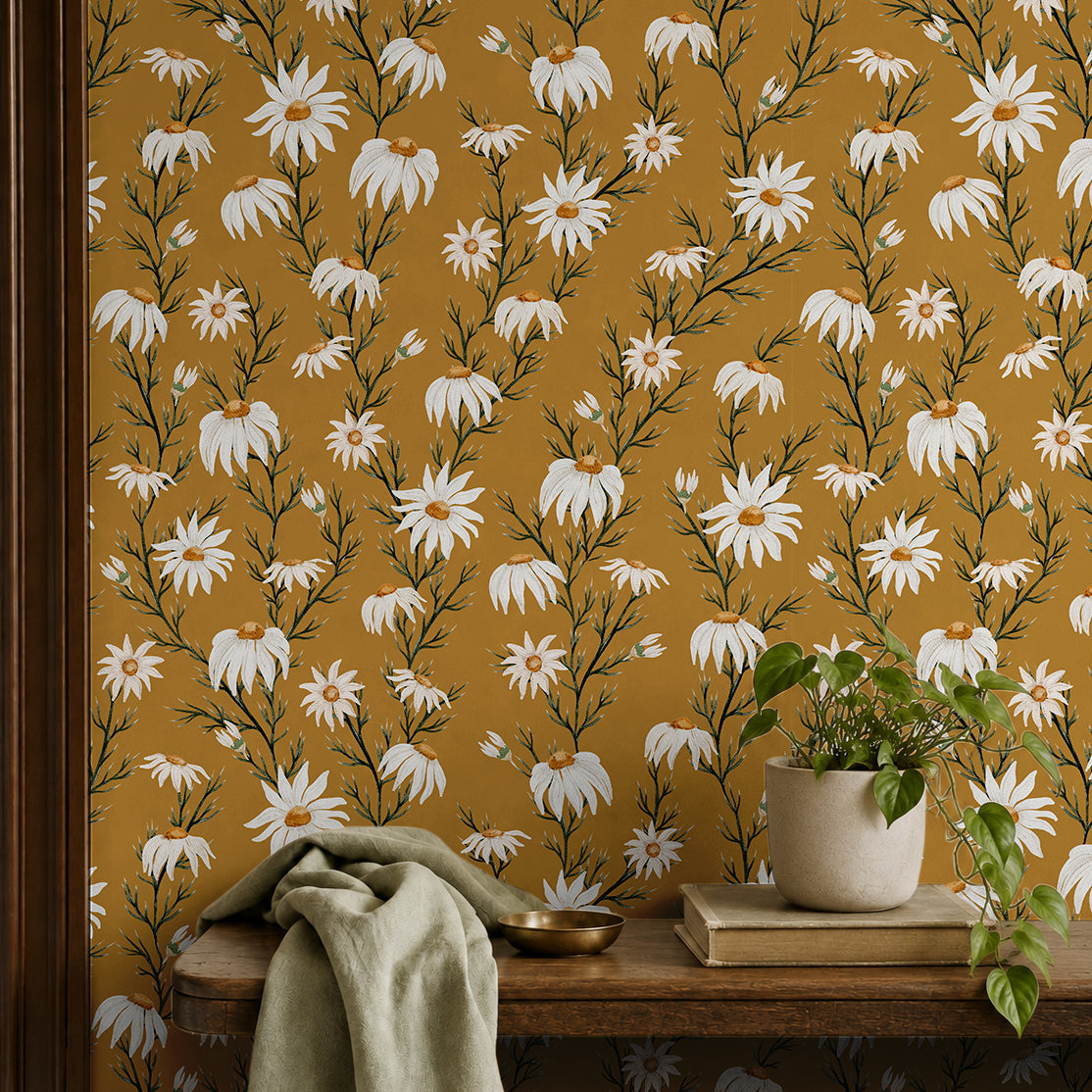 wallpaper with white daisies on a golden yellow background behind entryway shelf