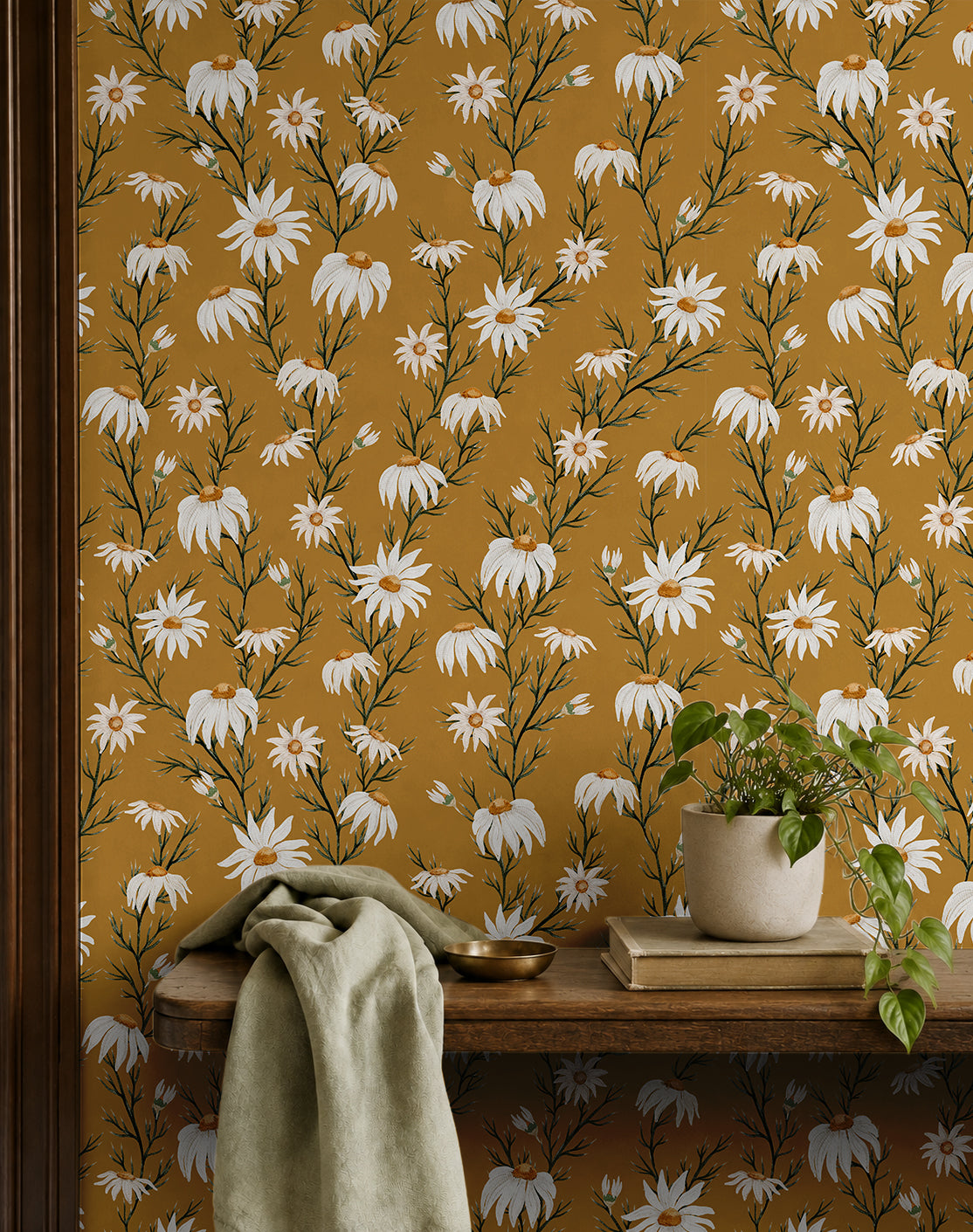 wallpaper with white daisies on a golden yellow background behind entryway shelf