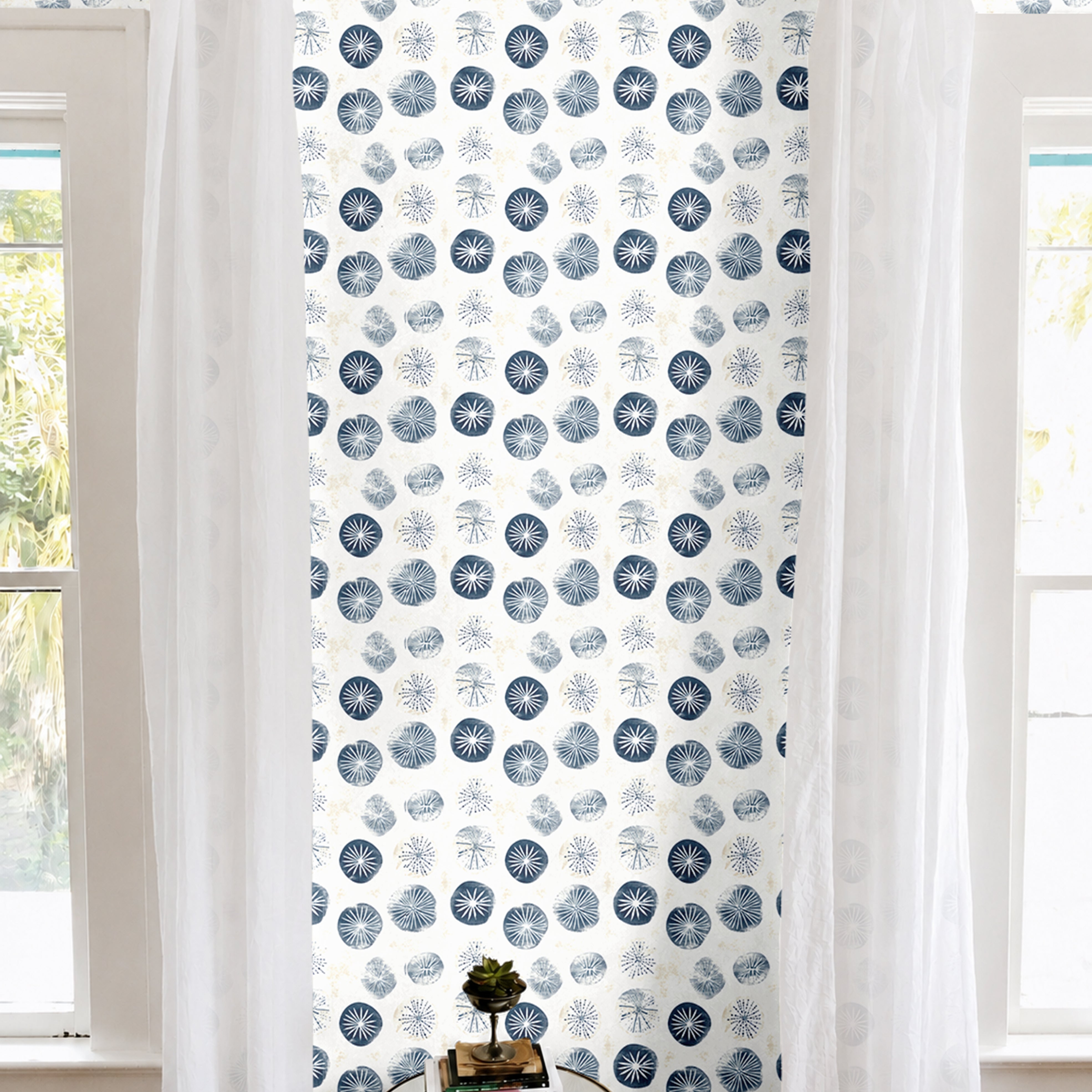 Navy and white sand dollar geometric print in brightly lit white living room