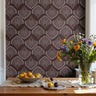 Dining room interior featuring Port & Pin plum geometric wallpaper with ivory fan motifs and antique-gold accents.