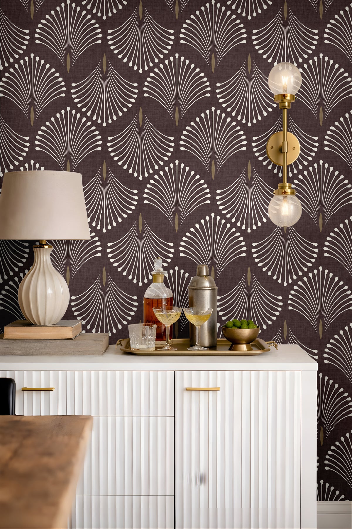 Living room bar cart styled with Port & Pin burgundy-plum wallpaper, repeating ivory fans and muted antique-gold details.