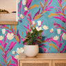 Blue Tropical Floral 2236 bold botanical wallpaper with vibrant pink foliage, cream flowers and golden accents on a bright blue background