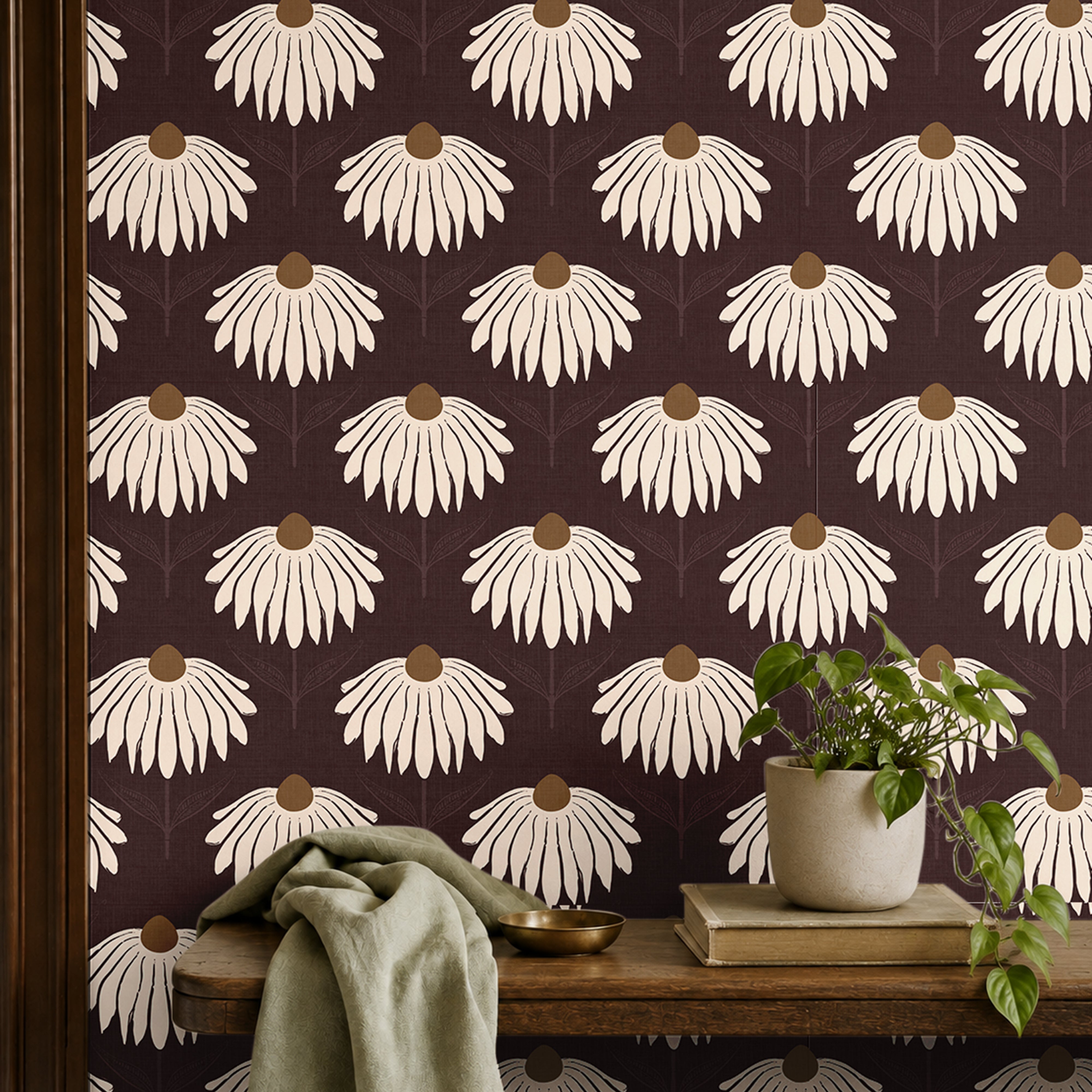 garnet crown 3543 burgundy coneflower wallpaper behind wood shelf with green plant books and sage fabric