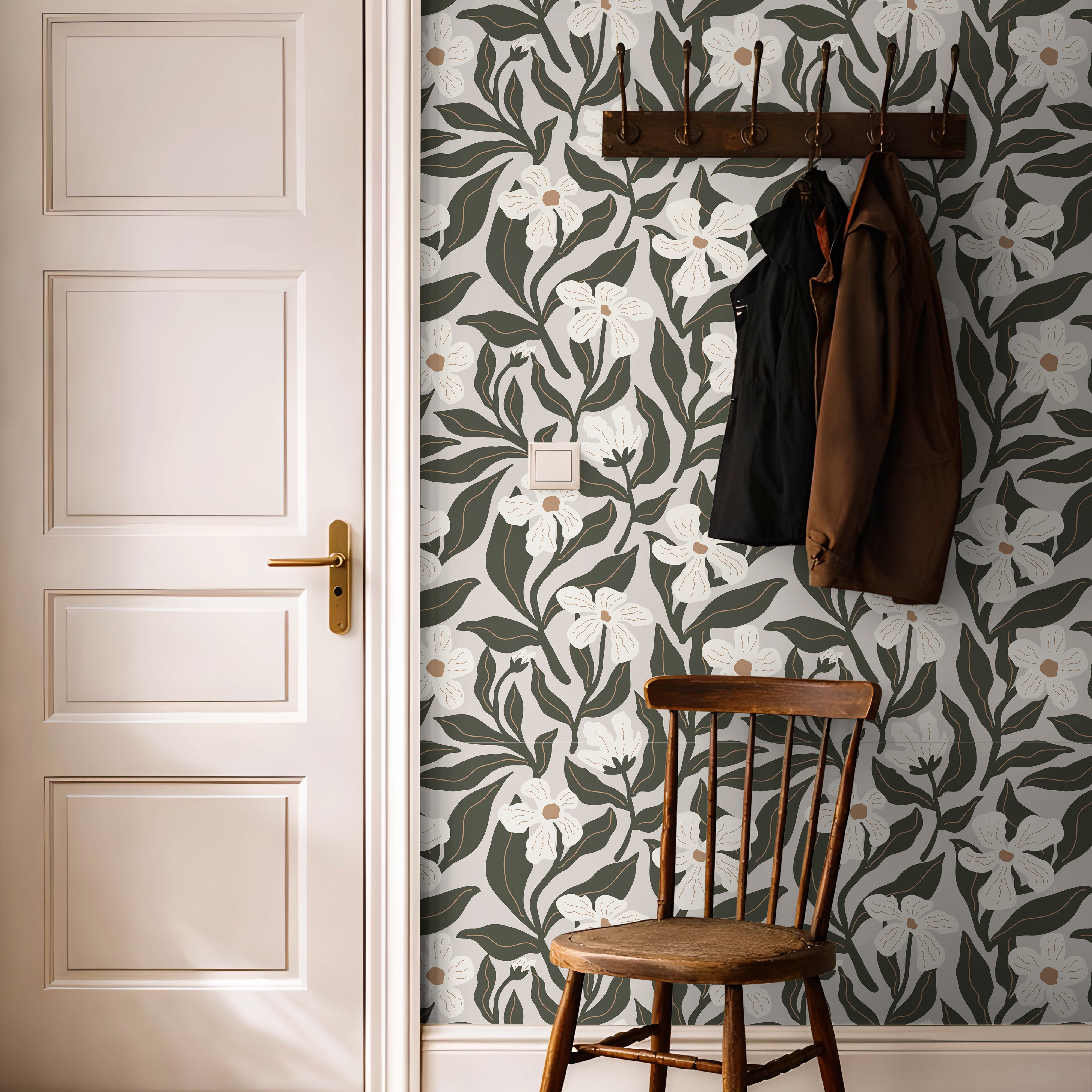 olive and ivory floral wallpaper in an entryway behind a simple wooden chair and coat rack