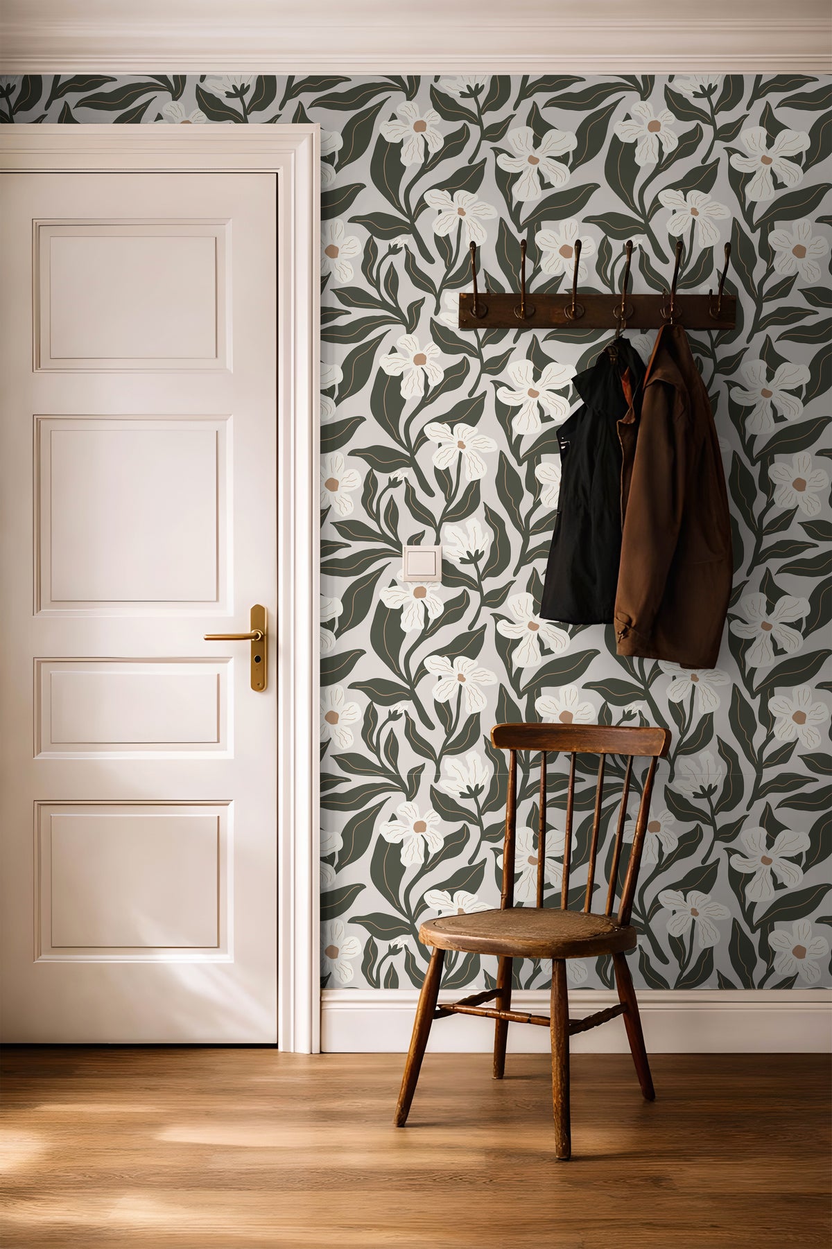 olive and ivory floral wallpaper in an entryway behind a simple wooden chair and coat rack