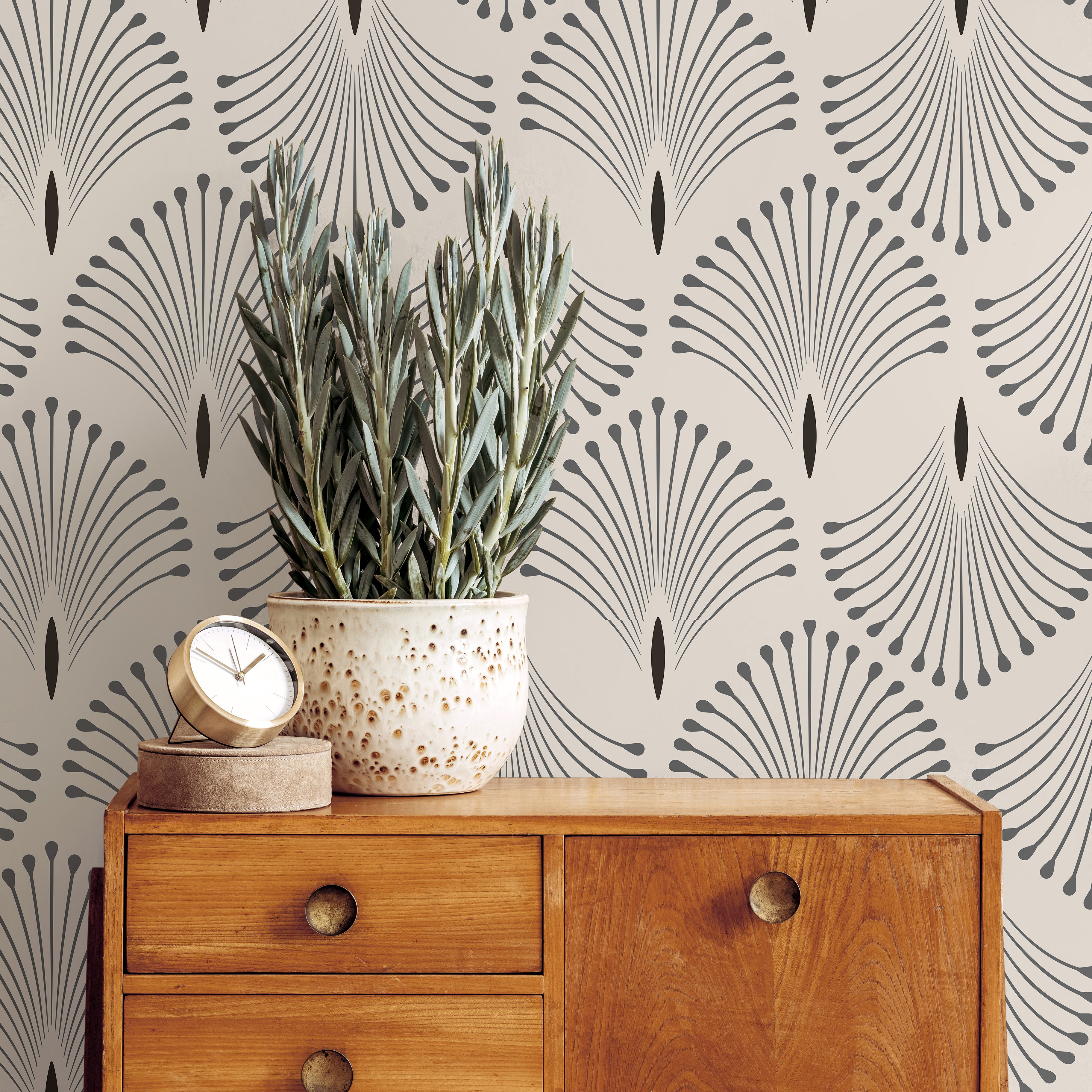 Neutral Art Deco wallpaper with repeating fan motifs styled beside warm wood furniture and soft organic decor