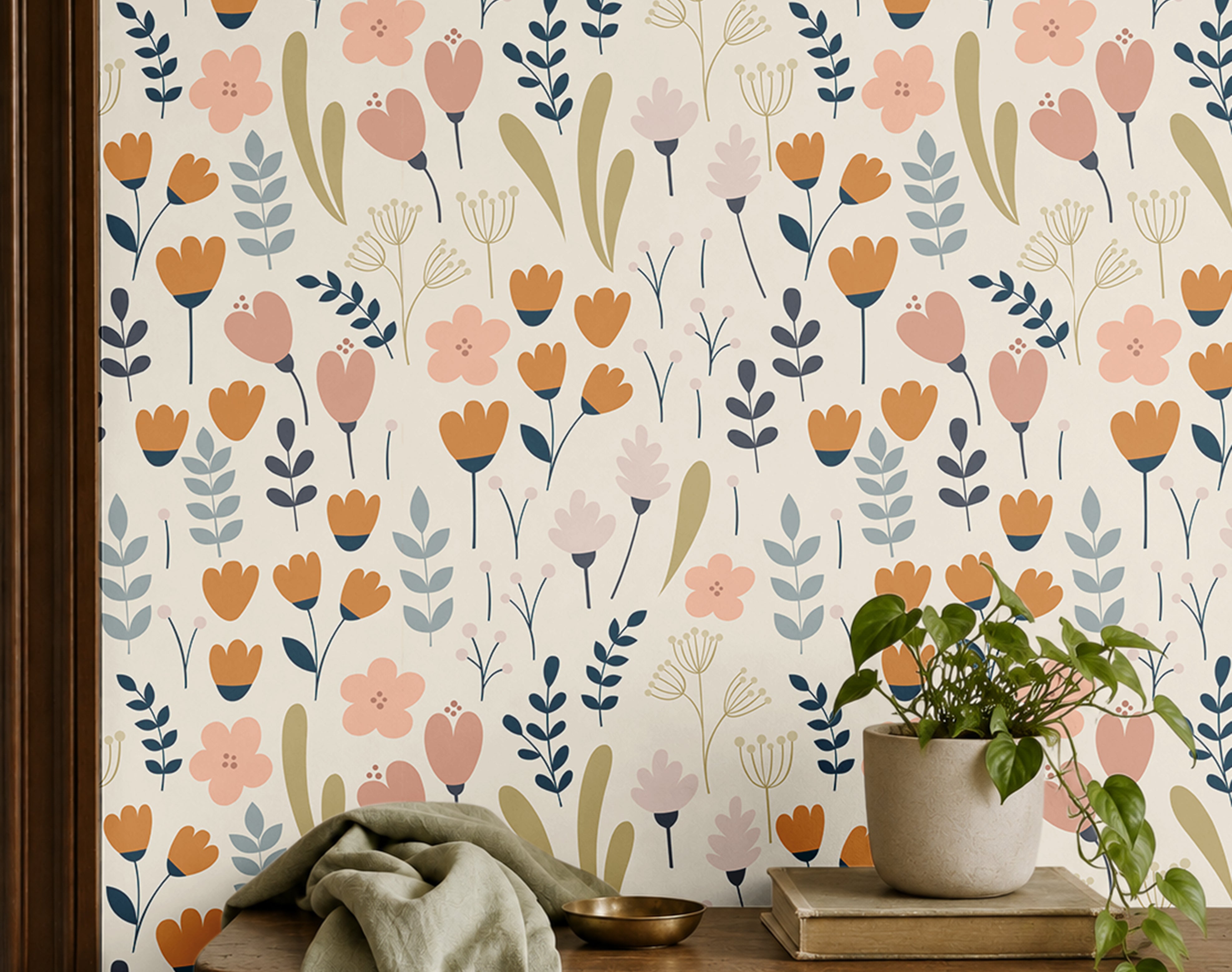 cream floral wallpaper in home office with warm wood shelf with plants books and cloth
