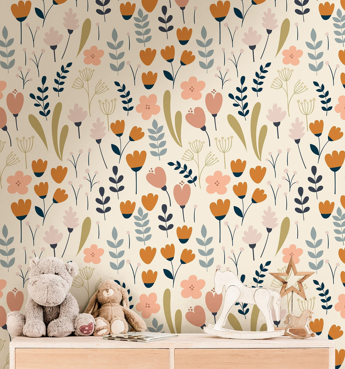 cream floral wallpaper in kids bedroom with pale wood bed mustard pillow blush decor and woven
storage