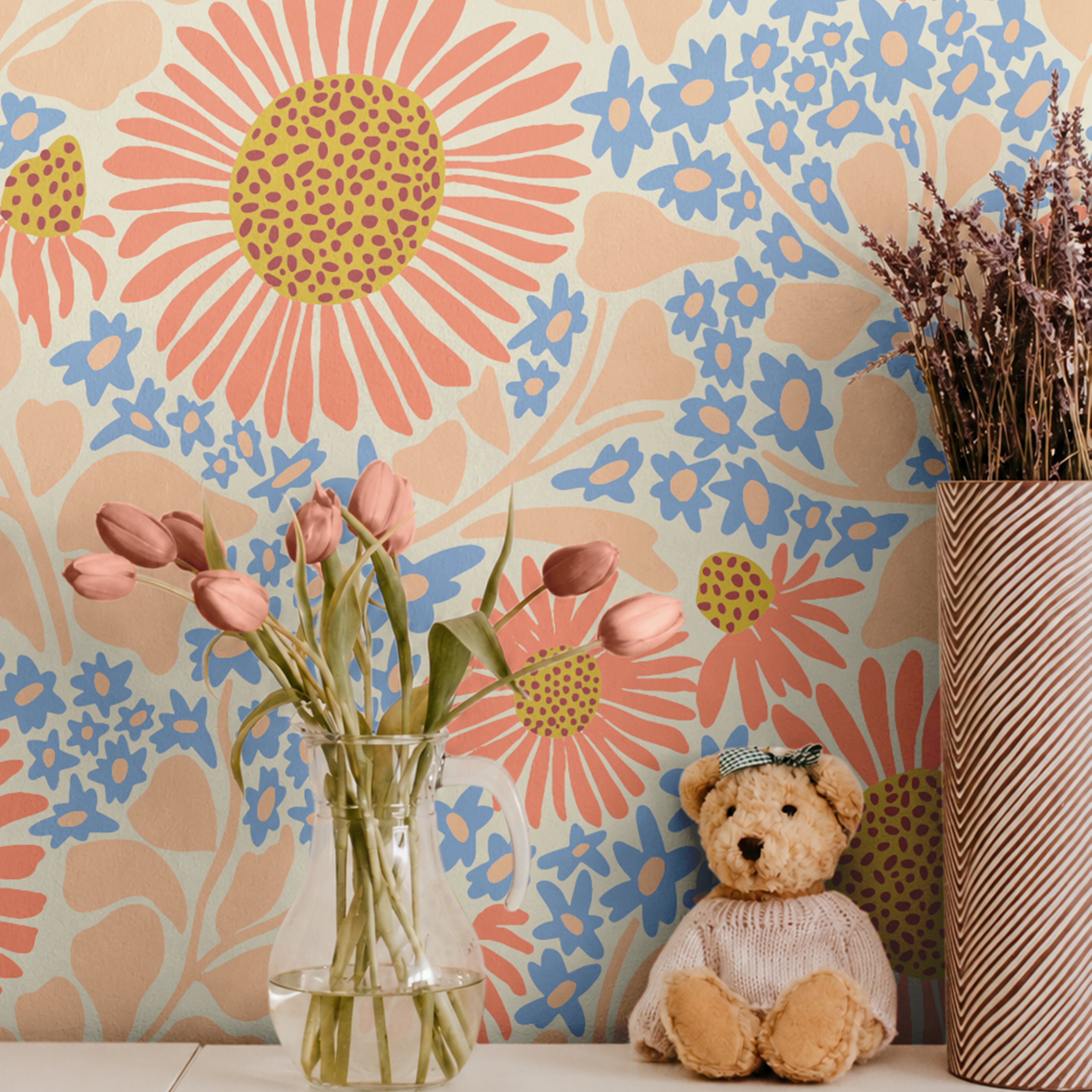 Warm Bloom coral and blue floral wallpaper with oversized wildflowers styled in a cheerful kids room with tulips and teddy bear