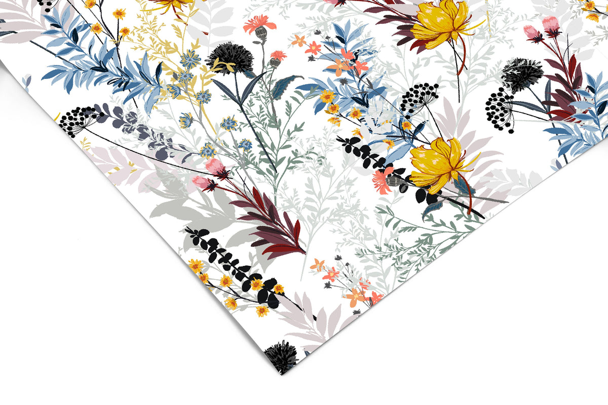 Close-up of Wildflower Wonderland peel and stick contact paper showing blue ferns, yellow and coral blooms, and dark seed heads on white